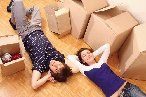 Professional movers unloading furniture at a Brentpark property